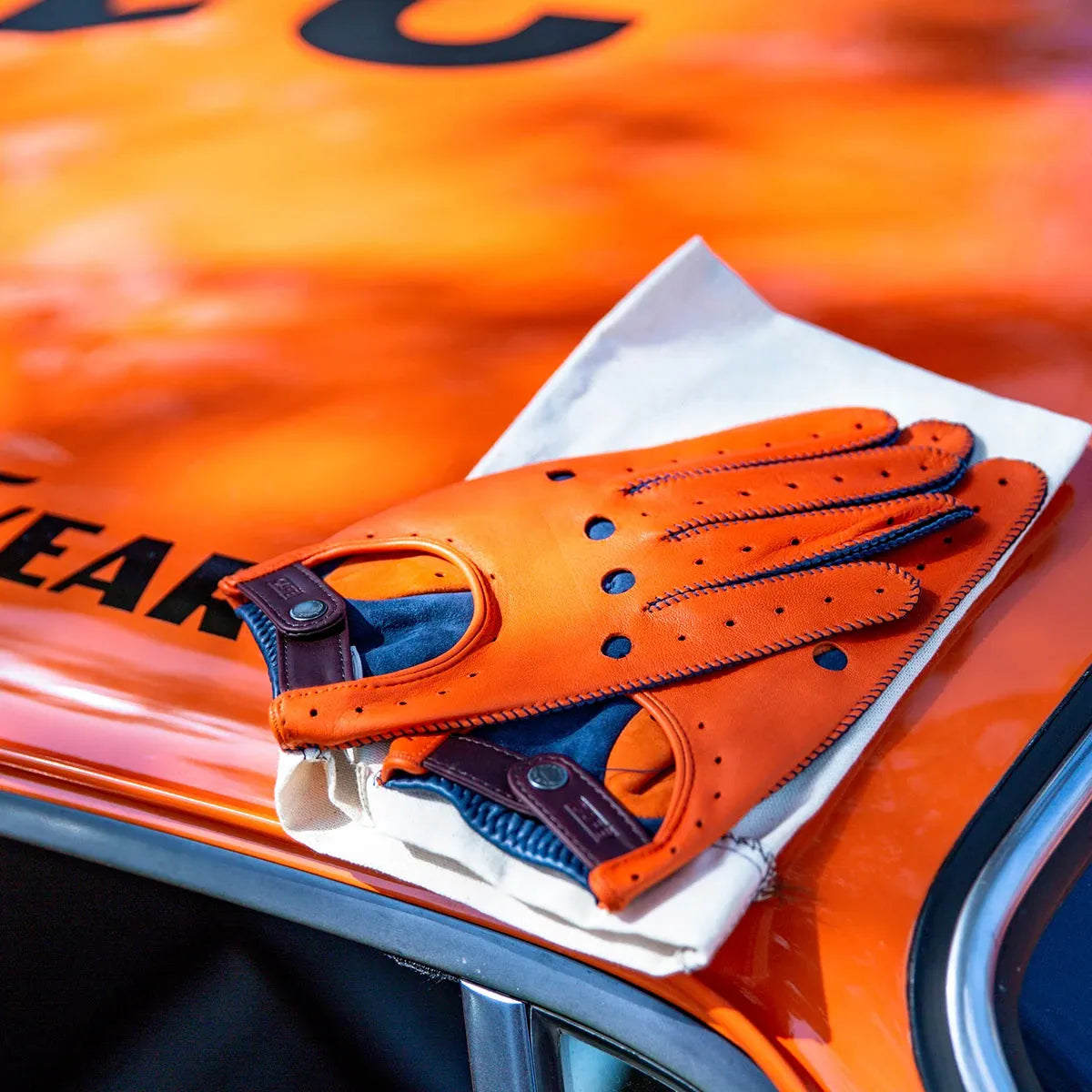 Triton Driving Gloves in Orange & Marlin